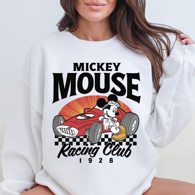 a woman wearing a mickey mouse racing club sweatshirt