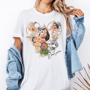 a woman wearing a white shirt with disney characters on it