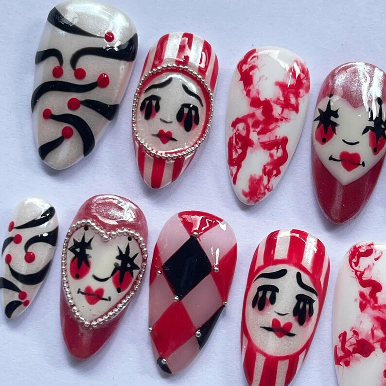 halloween press on nails, creepy clown fake nails, harlequin nail art, red black white nails, spooky costume nails, handmade halloween nails, circus clown nails, cosplay press on nails, gothic carnival nails, party fake nails set, scary clown nail art, unique halloween nails, spooky cosplay nails, holiday nails, canival nails, party nails