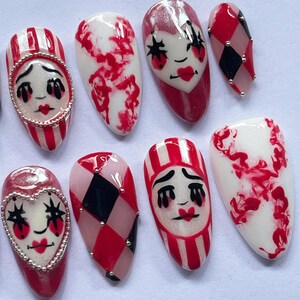 halloween press on nails, creepy clown fake nails, harlequin nail art, red black white nails, spooky costume nails, handmade halloween nails, circus clown nails, cosplay press on nails, gothic carnival nails, party fake nails set, scary clown nail art, unique halloween nails, spooky cosplay nails, holiday nails, canival nails, party nails