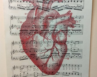 red vintage anatomical heart on vintage sheet music valentine's day halloween love