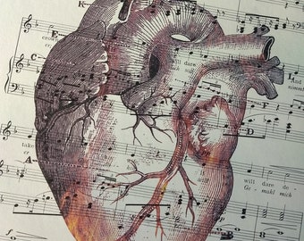 vintage "flaming" anatomical heart on vintage sheet music valentine's day halloween love