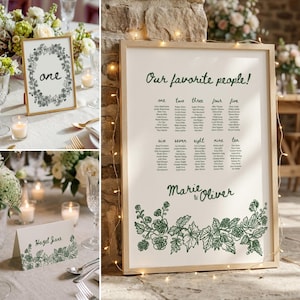 May include: A framed wedding seating chart with the text "Our favorite people!" and names, plus a table number card and a table number sign. The design features green floral illustrations and the names "Marie & Oliver".