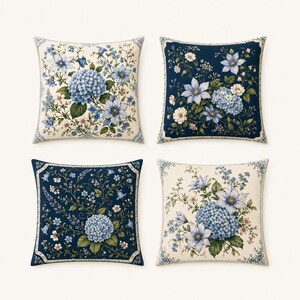 May include: Four square throw pillows with floral designs. Each pillow features a different arrangement of blue and white flowers, including hydrangeas and other blossoms, against a cream or navy background. The pillows have a decorative border.