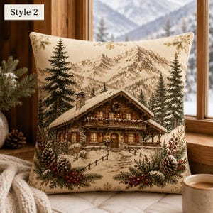 May include: A square throw pillow featuring a woven scene of a snow-covered wooden cabin in a mountain forest. The design includes tall pine trees, a stone chimney, and a foreground decorated with pine cones and red berries. Text reads Style 2.