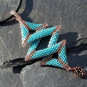 May include: A turquoise and copper beaded pendant necklace with a geometric design. The pendant is made of multiple triangles that are interlocked. The necklace is attached to a black cord.