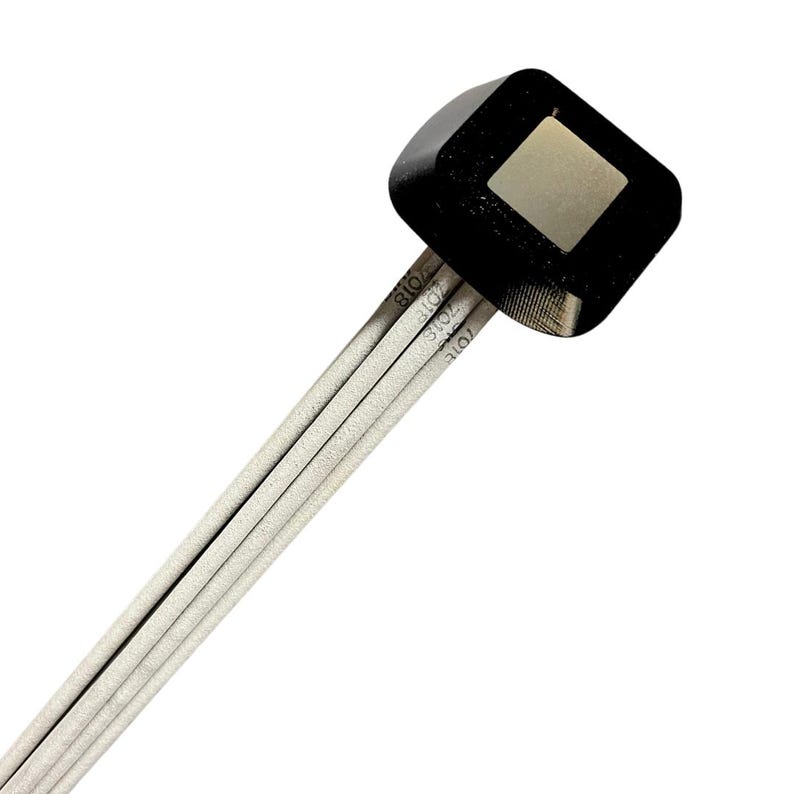 May include: A black square sensor with a silver square in the center, attached to a bundle of five white wires.