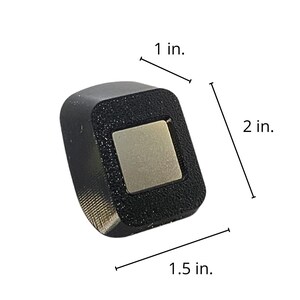May include: A black square-shaped object with a silver square in the center. The object is 1 inch wide, 1.5 inches long, and 2 inches tall. The object is labeled with measurements in inches.