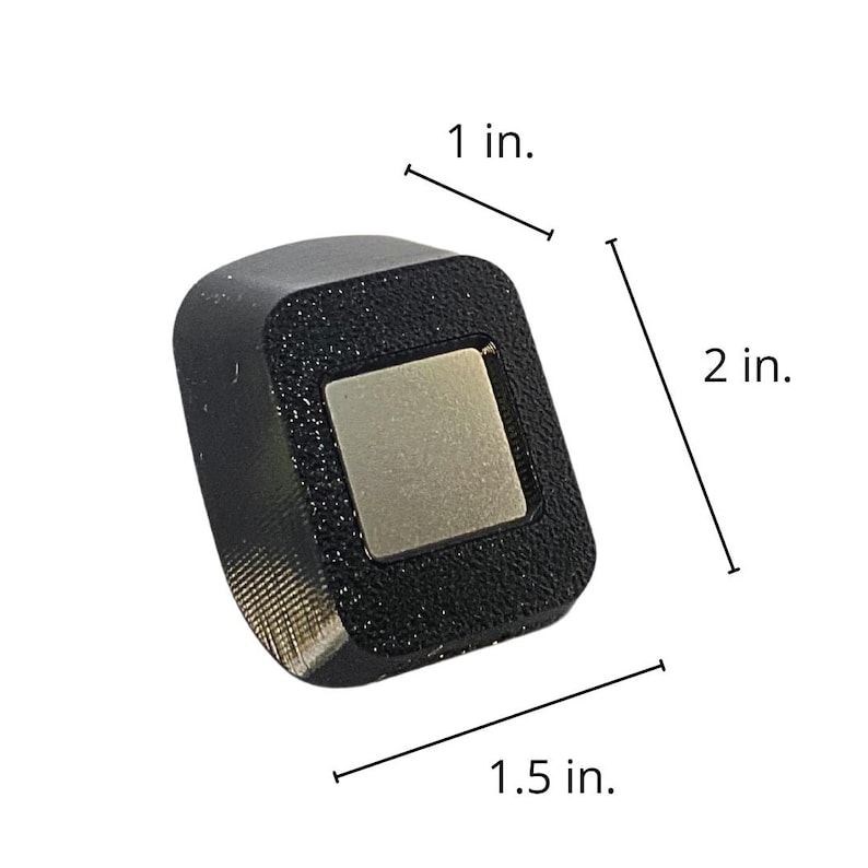 May include: A black square-shaped object with a silver square in the center. The object is 1 inch wide, 1.5 inches long, and 2 inches tall. The object is labeled with measurements in inches.