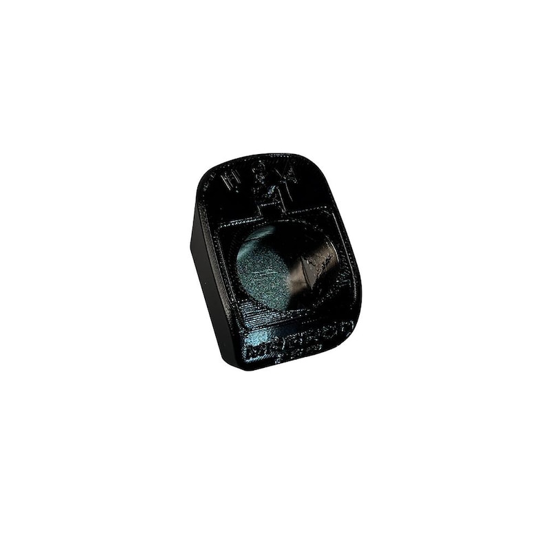 May include: Black plastic object with a raised circular design and the words 'W.A.T.E.R. PROOF' printed on it.