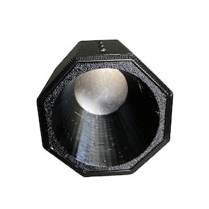 May include: A black, octagonal-shaped object with a textured surface. The object has a large, circular opening at one end and a smaller opening at the other. The interior is a smooth, dark surface. The object appears to be made of plastic.