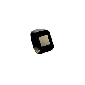 May include: A black square-shaped object with a slightly raised, rectangular, silver-colored surface in the center.