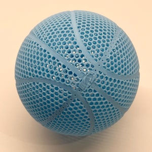 May include: A light blue basketball with a mesh design. The basketball has a traditional design with white lines.