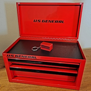 May include: Red metal toolbox with three drawers and a black label that says "U.S. GENERAL".