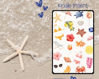 May include: A Kindle Insert with watercolor illustrations of beach-themed items, including a starfish, bikini, sunglasses, and a crab. The text "Kindle Insert" is visible. The background shows a sandy beach and ocean waves.