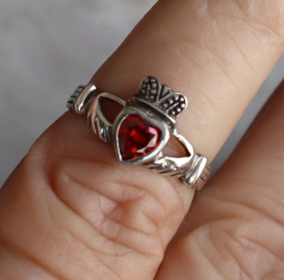 Hands holding heart ring deals