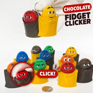 May include: A collection of colorful, smiling candy-shaped fidget clickers. The fidget toys are in various colors, including red, yellow, blue, green, orange, and brown. The text "CHOCOLATE FIDGET CLICKER" and "CLICK!" are also visible.