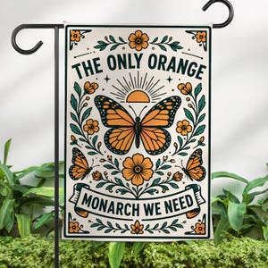 May include: A rectangular garden flag with a black metal stand. The flag features a monarch butterfly design with the text "THE ONLY ORANGE MONARCH WE NEED". The butterfly is orange and black, surrounded by orange flowers and green leaves.