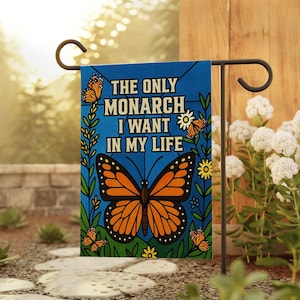 May include: A blue garden flag with the text "THE ONLY MONARCH I WANT IN MY LIFE." The flag features a large orange and black monarch butterfly and several smaller butterflies, with floral accents.