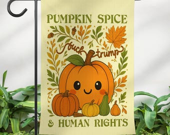 May include: A garden flag with a light yellow background features a cartoon pumpkin with a smiling face, surrounded by smaller pumpkins and leaves. The text reads "PUMPKIN SPICE" and "& HUMAN RIGHTS", with the phrase "fuck trump" in the center.