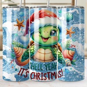 May include: A stainless steel tumbler with a festive design. The tumbler features a cartoon turtle wearing a Santa hat, surrounded by seashells and starfish. Text on the tumbler reads "Shell Yeah! It's Christmas!"