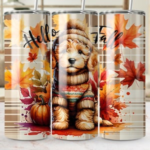 May include: A stainless steel tumbler featuring a watercolor design with a puppy wearing a hat and sweater, surrounded by fall leaves and a pumpkin. The words "Hello Fall" are written in a script font across the top.