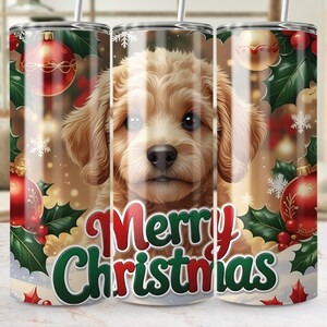 May include: A stainless steel tumbler featuring a golden-brown puppy with a festive Christmas design. The tumbler is decorated with red ornaments, holly, snowflakes, and the words "Merry Christmas" in red and green.