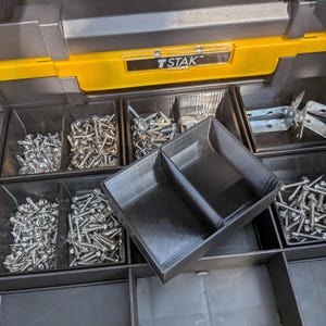 May include: A black and yellow DeWalt TSTAK tool organizer featuring multiple compartments filled with various metal screws and hardware. A removable black plastic insert with two sections sits prominently in the center of the open storage tray.