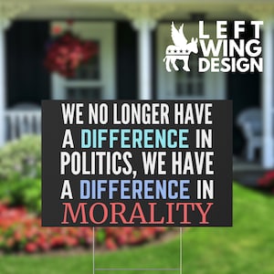 May include: Black sign with white text that reads "WE NO LONGER HAVE A DIFFERENCE IN POLITICS, WE HAVE A DIFFERENCE IN MORALITY." The sign has a logo of a winged donkey and the words "LEFT WING DESIGN."