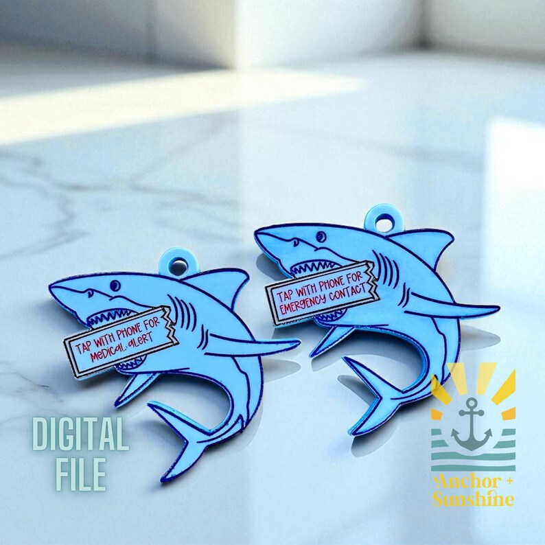 May include: Two light blue shark-shaped tags with a hole at the top. Each shark holds a rectangular sign with text: "TAP WITH PHONE FOR MEDICAL ALERT" and "TAP WITH PHONE FOR EMERGENCY CONTACT". The words "DIGITAL FILE" are also visible.