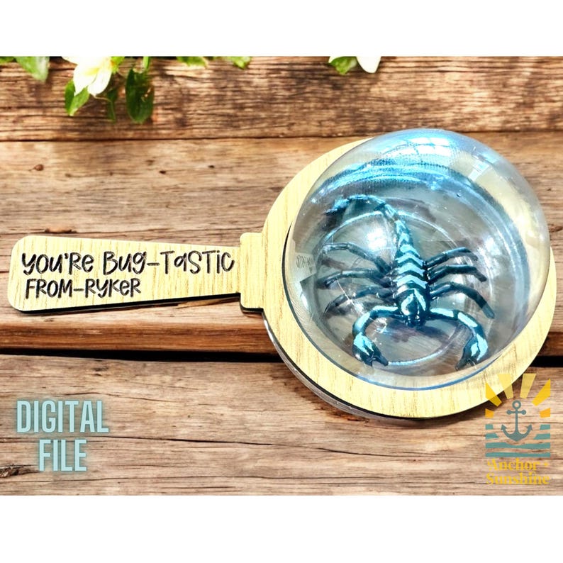 May include: A wooden magnifying glass with a blue scorpion inside. The handle has the text "You're Bug-Tastic From-Ryker" on it.
