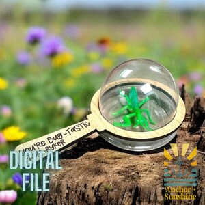 May include: A wooden magnifying glass with a clear plastic dome, containing a green plastic bug. The handle is engraved with the text "You're Bug-Tastic Ryker". The text "DIGITAL FILE" is visible in the lower left corner of the image.