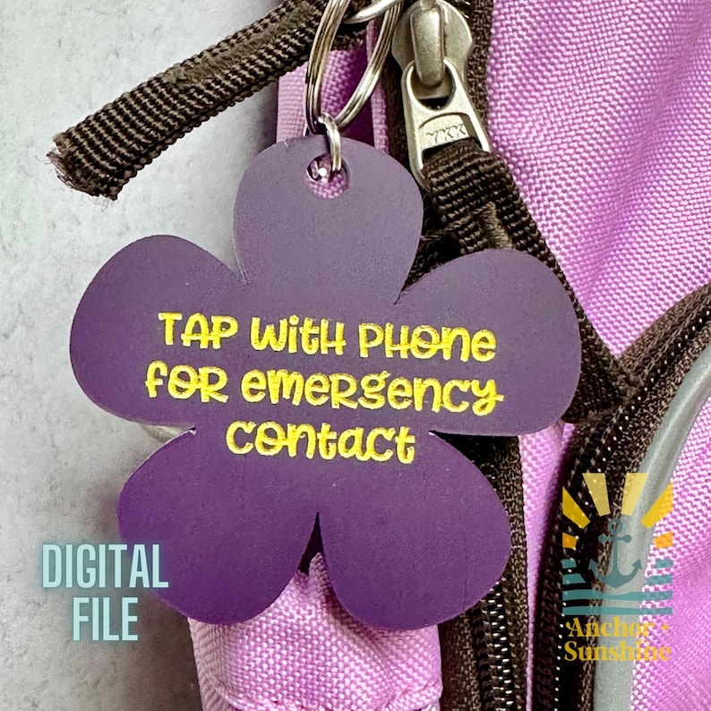 May include: Purple flower-shaped keychain with the text "TAP with PHONE for emergency contact" in yellow. The keychain is attached to a backpack zipper. The words "DIGITAL FILE" are also visible.