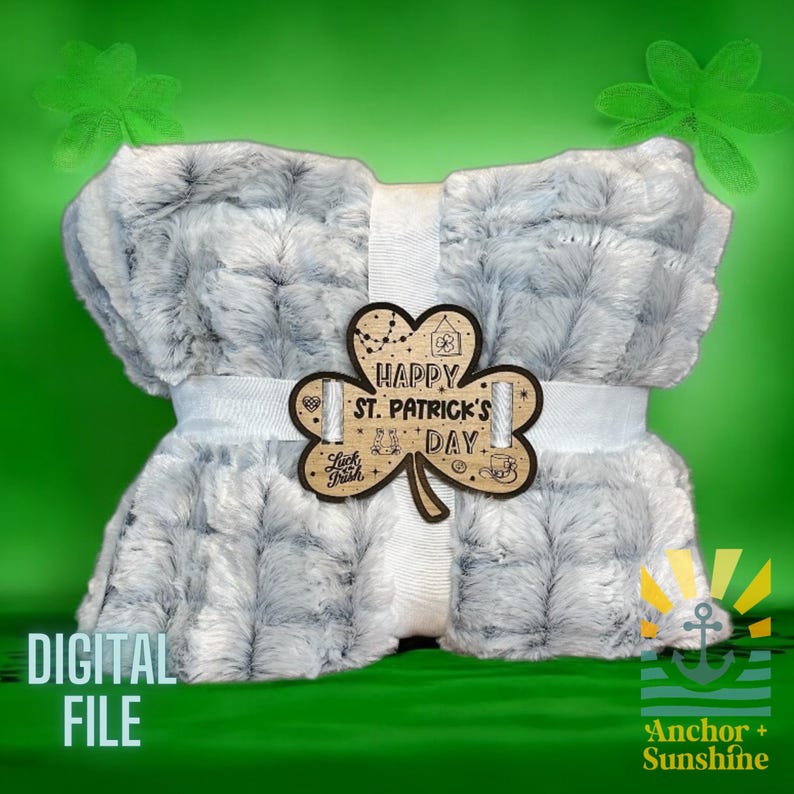 May include: A gray and white plush blanket with a wooden shamrock cutout that says "Happy St. Patrick's Day".