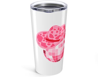 May include: White stainless steel tumbler with a pink disco ball and a pink cowboy hat with white spots on it.