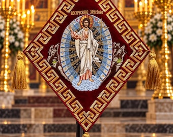 May include: A diamond-shaped maroon velvet liturgical banner featuring gold embroidered Greek key borders and three gold tassels. The center displays an embroidered figure of Christ with the Cyrillic text "ВОСКРЕСЕНИЕ ХРИСТОВО" above.