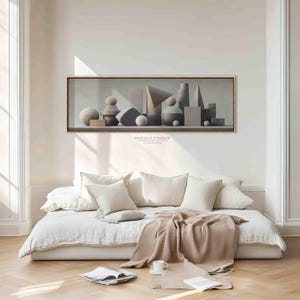 Könnte beinhalten: Ein gerahmter Leinwandkunstdruck mit einem Stillleben geometrischer Formen in Grau-, Beige- und Weißtönen. Das Kunstwerk umfasst Kugeln, Zylinder und Prismen. Der Text "DREAM FRAME CANVAS" ist auf der Leinwand sichtbar.