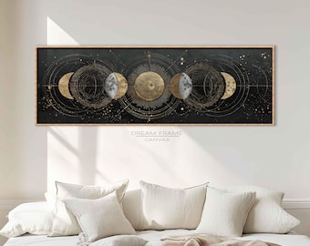 May include: A long, rectangular canvas print featuring a celestial design with phases of the moon in gold and silver against a black background. The artwork is framed in a light brown wooden frame. The text "DREAM FRAME CANVAS" is printed in white.