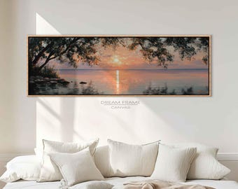Puede incluir: Una impresión en lienzo enmarcada de una puesta de sol sobre el agua. La obra presenta un cielo naranja y rosa vibrante que se refleja en la superficie del agua, con ramas oscuras en la parte superior. El texto "DREAM FRAME CANVAS" es visible.