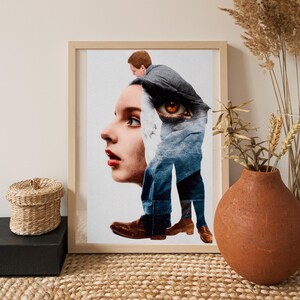 May include: Framed art print featuring a surreal collage. The artwork combines a woman's profile with a man's form, including an eye and legs. The color palette includes shades of brown, blue, and white, creating a thought-provoking visual.