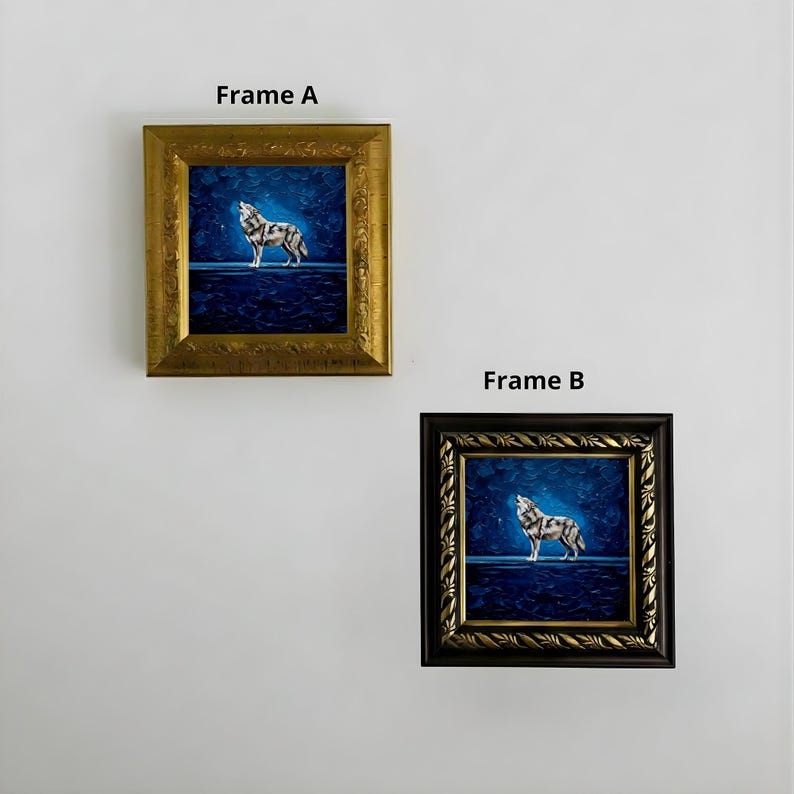 May include: Two framed square paintings of a howling wolf against a dark blue background. One frame is gold, the other is black with gold accents. The paintings are displayed on a white wall. The text "Frame A" and "Frame B" are above the frames.