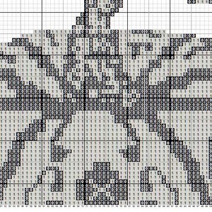 Close-up of stitches from Halloween pumpkin cross stitch design, showing chart grid and texture details.