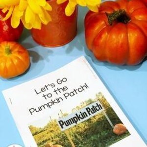 May include: A vibrant autumn scene featuring a small orange pumpkin, a larger pumpkin, and a vase of yellow flowers. A book titled "Let's Go to the Pumpkin Patch!" is in the foreground. The book's cover shows a sign that reads "Pumpkin Patch".