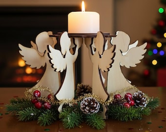 May include: A wooden angel candle holder with a lit white candle. The holder features four angel figures supporting a platform. The base is decorated with greenery, red berries, gold tinsel, and pinecones, creating a festive holiday centerpiece.