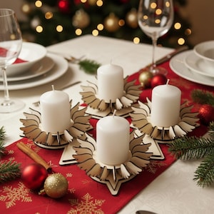 May include: Four white pillar candles sit in decorative wooden candle holders on a red tablecloth. The candle holders have a star-shaped base and a sunburst design. The table is set for a holiday meal with plates, glasses, and ornaments.