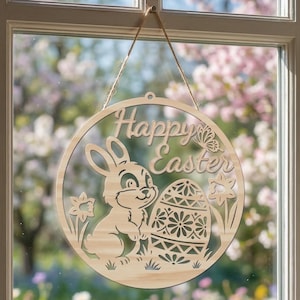 May include: Wooden Easter decoration with a circular design. The sign features the words "Happy Easter", a bunny, an Easter egg, and floral accents. The sign is hanging by a natural twine string.