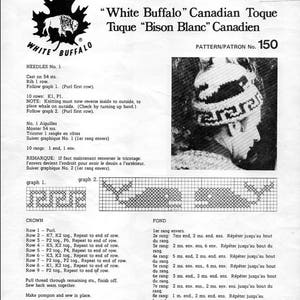 May include: A black and white illustration of a buffalo head with the words "White Buffalo" above it. The text "Canadian Toque" is below the buffalo head. The text "Tuque "Bison Blanc" Canadien" is below the text "Canadian Toque". The text "Pattern/Patron No. 150" is below the text "Tuque "Bison Blanc" Canadien".