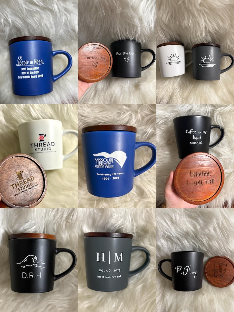 May include: Collection of ceramic mugs with wooden lids. Mugs are various colors, including blue, black, white, and gray. Some mugs have text like "People in Need" and "Coffee is my liquid sunshine." Others feature initials or logos. The lids are engraved.