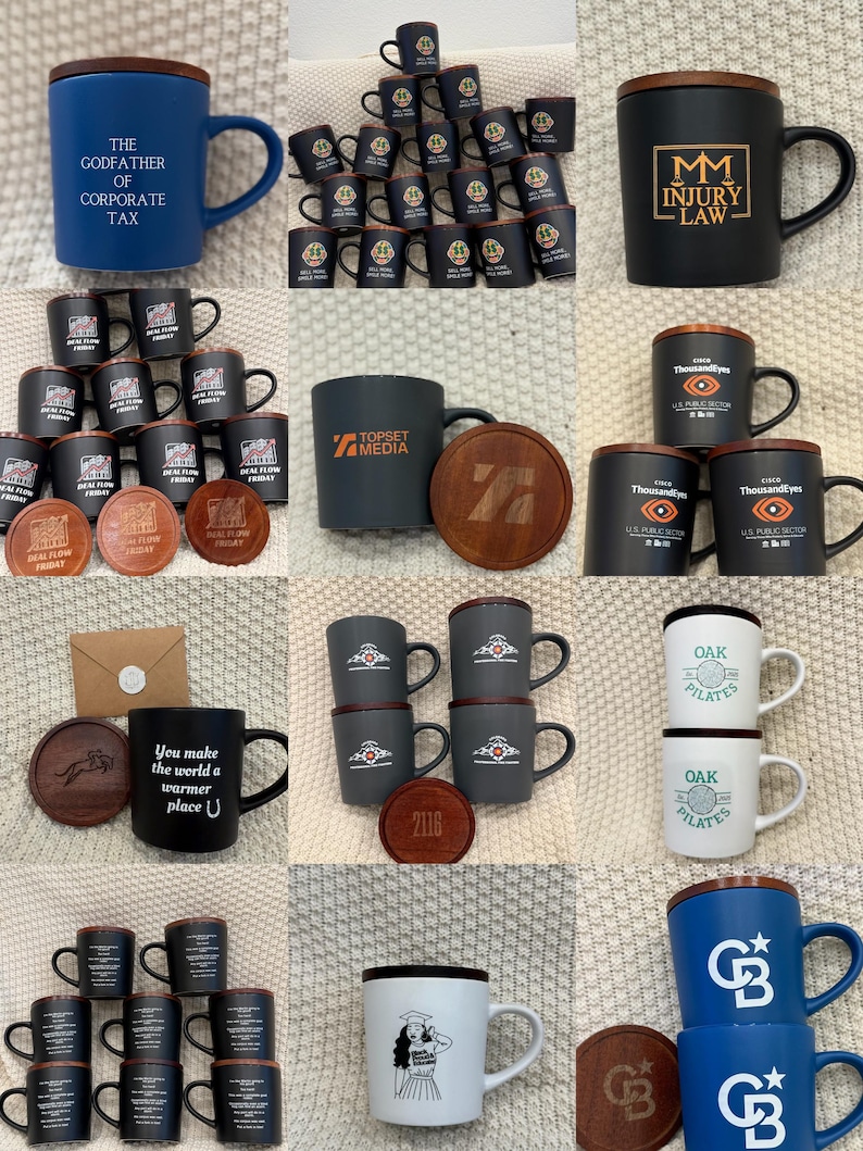 May include: Collection of ceramic mugs with various designs and text, including "The Godfather of Corporate Tax," "MM Injury Law," and "Oak Pilates." Some mugs have wooden lids and matching coasters. Colors include blue, black, white, and gray.