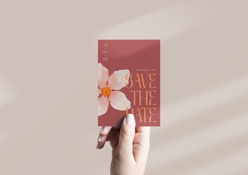 May include: A save the date card with a pink flower illustration and the text "Save the Date" in orange. The date is listed as 10.07.25. The names "Simona & Tom" are printed at the top of the card.